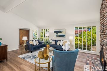 Mercer Island house for rent - A living room with a blue couch and a gold side table.
