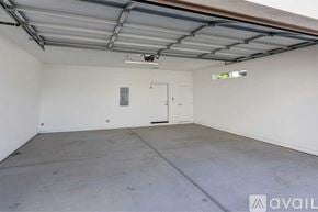 Phoenix apartment for rent - A spacious garage with a closed door and a ceiling fan.