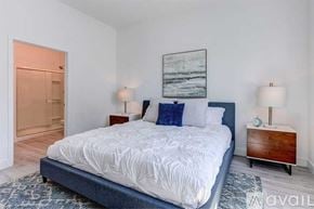 Phoenix apartment for rent - A bedroom with a large bed and a painting on the wall.