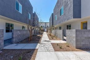 Phoenix apartment for rent - A modern building with a concrete exterior and a pathway leading to the entrance.