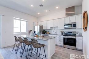 Phoenix apartment for rent - A modern kitchen with white cabinets and a center island.