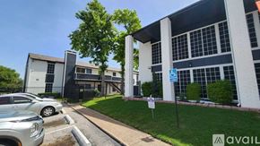 Dallas apartment for rent - A parking lot with cars and a building in the background.