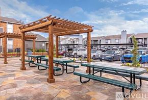 Dallas apartment for rent - A parking lot with cars and a building in the background.