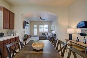 Merced house for rent - A dining room with a wooden table and chairs.