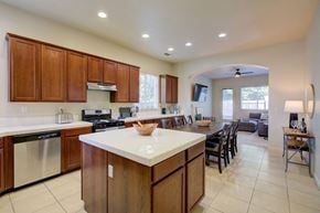 Merced house for rent - A kitchen with wooden cabinets and a white countertop.