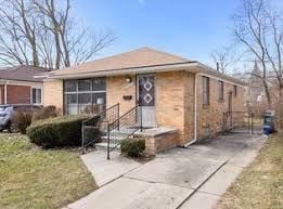 Oak Park house for rent - A small house with a brick facade and a black metal fence.
