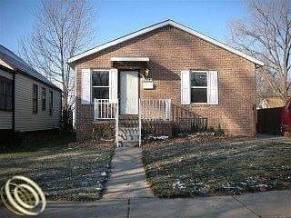 Redford Charter Township house for rent - A small brick house with a white door and a small porch.