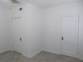 Dallas apartment for rent - A room with two white doors and a ceiling fan.