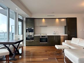 Vancouver house for rent - A modern kitchen with a dining table and chairs.