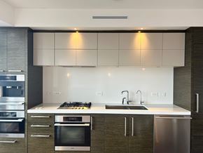 Vancouver house for rent - A modern kitchen with a stainless steel oven and sink.