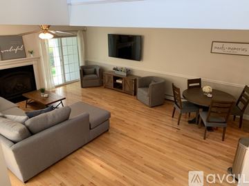 Old Orchard Beach townhouse for rent - A living room with a grey sofa and a wooden floor.