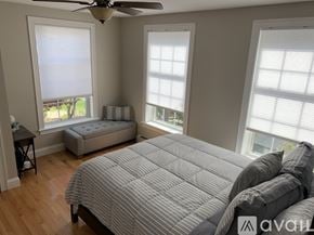 Old Orchard Beach townhouse for rent - A bedroom with a large bed and a window with blinds.