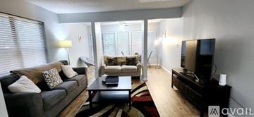 Sandy Springs house for rent - A living room with a grey couch and a black coffee table.