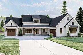 Fort Gibson house for rent - A large white house with a black roof and a garage door.