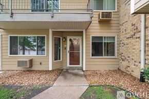 Minneapolis condo for rent - A two-story house with a balcony on the upper floor.