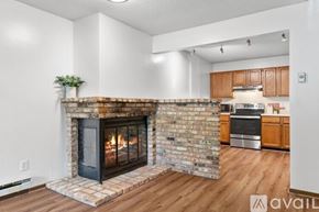 Minneapolis condo for rent - A room with wooden flooring and a fireplace.