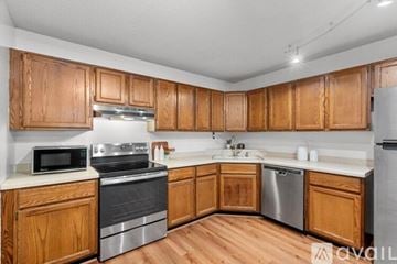Minneapolis condo for rent - A kitchen with wooden cabinets and stainless steel appliances.