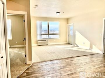 Missoula apartment for rent - A spacious living room with a large window and a rug on the floor.
