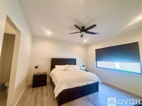 Lake Havasu City house for rent - A bedroom with a large bed and a ceiling fan.