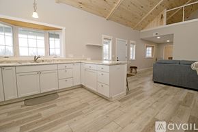 Annandale apartment for rent - A kitchen with a white refrigerator and a black stove top oven.