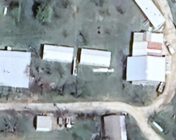 Clyde house for rent - A small village with a few buildings and a dirt road.