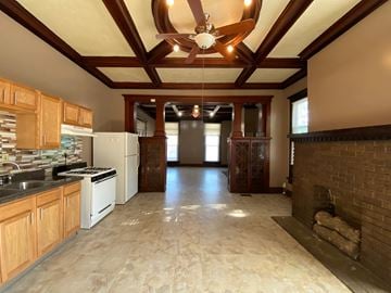 Louisville apartment for rent - A kitchen with wooden cabinets and a brick fireplace.