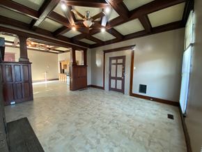 Louisville apartment for rent - A large empty room with a wooden ceiling and floor.