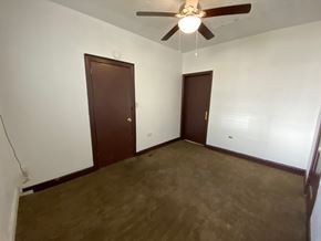 Louisville apartment for rent - A room with a ceiling fan and two doors.