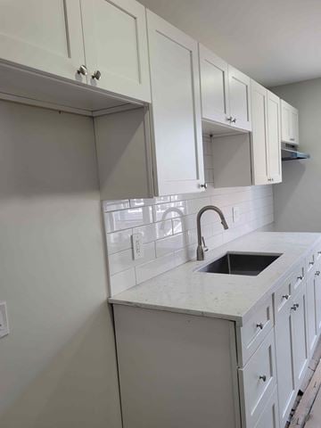 Pictou apartment for rent - A kitchen with white cabinets and a white countertop.
