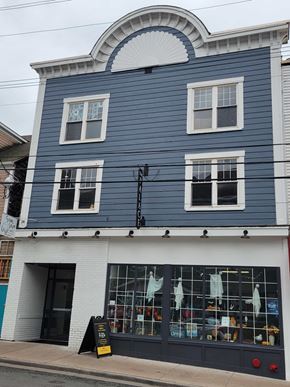 Pictou apartment for rent - A blue building with a white trim and a black awning.