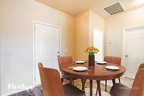 Montevallo house for rent - A dining room with a round table set for six.