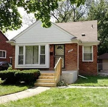 Oak Park house for rent - A small house with a white front porch and a brown brick exterior.
