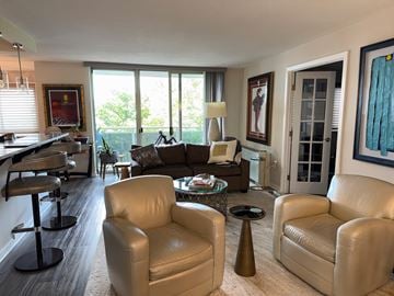 Takoma Park house for rent - A living room with a white couch and a brown chair.