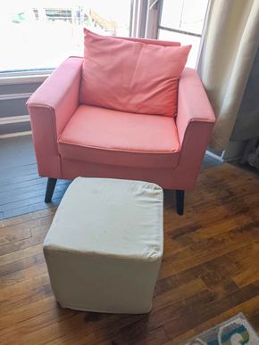 Trinidad apartment for rent - A pink chair with a pink pillow and a white ottoman.