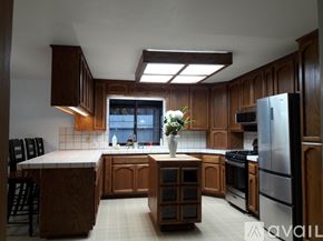 Benicia house for rent - A kitchen with wooden cabinets and a large island.