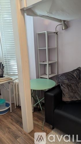 Elizabeth apartment for rent - A living room with a black couch and a small table.