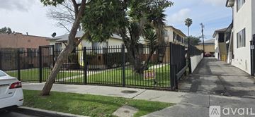 Los Angeles apartment for rent - A kitchen with white cabinets and a black countertop.