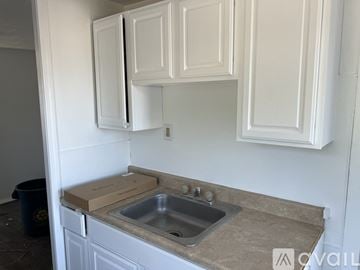 Hamilton Township apartment for rent - A kitchen with white cabinets and a granite countertop.