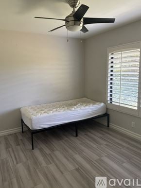 Irvine townhouse for rent - A bedroom with a bed, desk, and chair.