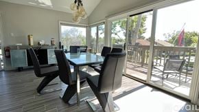 Irvine townhouse for rent - A modern dining room with a glass table and chairs.
