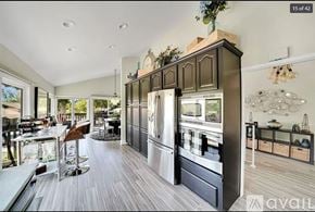 Irvine townhouse for rent - A modern kitchen with dark wood cabinets and a large island.