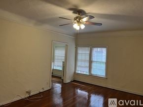 Los Angeles apartment for rent - A room with a ceiling fan and two windows.