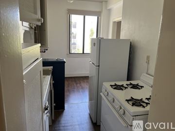 Los Angeles apartment for rent - A kitchen with a white fridge, stove and a window.