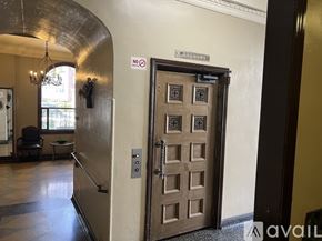 Los Angeles apartment for rent - A brown door with a sign on the wall above it.