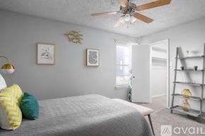 San Antonio apartment for rent - A bedroom with a bed, a ceiling fan, and a window.