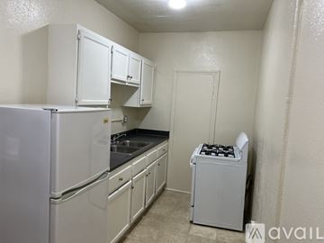Los Angeles apartment for rent - A small kitchen with white appliances and cabinets.