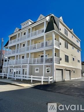 Hampton condo for rent - A large white building with a balcony on the second floor.