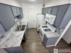 Fort Stockton apartment for rent - A kitchen with white cabinets and a black stove top.