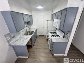 Fort Stockton apartment for rent - A kitchen with a stove, sink, and cabinets.