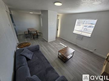 Fort Stockton apartment for rent - A living room with a grey couch and a wooden coffee table.